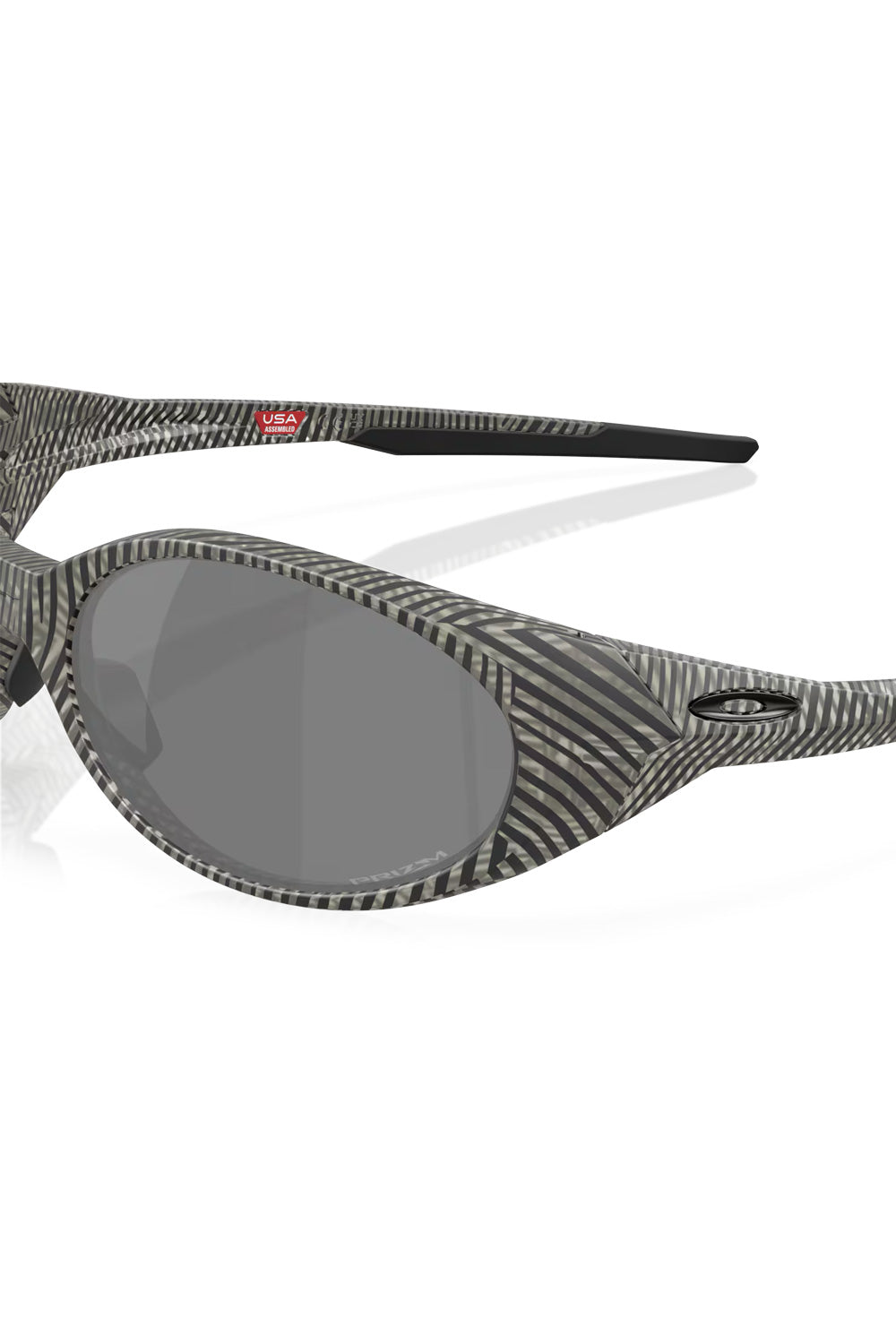 Close-up view of the Oakley Eye Jacket Redux hinge area, showcasing the detailed grey fingerprint texture, black ellipse logo, and Prizm lens etching.