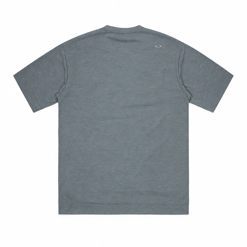 Back studio flat lay perspective of the Oakley FGL Scratch SS Tee 6.7 in Acrid Green, displaying the clean shoulder seam construction, straight hemline, subtle heathered green knit texture, and a reflective silver heat-sealed Oakley Ellipse logo centered beneath the rear collar band.