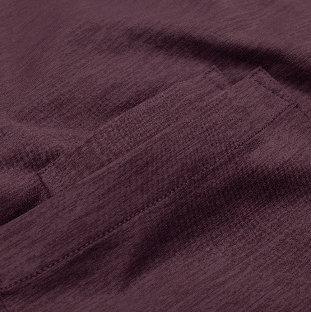 Detailed macro perspective of the upper chest pocket opening on the Oakley FGL Scratch Tee, highlighting the reinforced bartack corner stitching, clean double-needle edge hem, and the subtle striations of the performance heathered fabric.