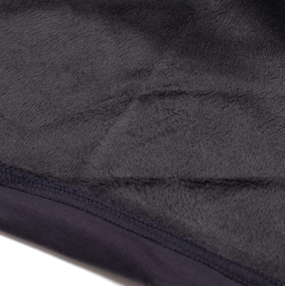 Macro studio perspective of the bottom hem interior on the Oakley FGL Slick Fleece Hoodie in Phantom, detailing the ultra-dense, velvety black high-pile plush faux-fur sherpa fleece backing and reinforced stretch flatlock edge hem stitching.