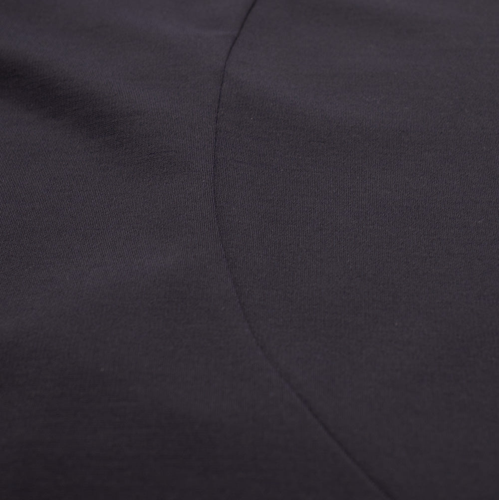 Close-up studio perspective of the curved ergonomic side seam construction on the Oakley FGL Union Tee, detailing the smooth, matte surface texture and breathable synthetic knit fabric designed for active outdoor comfort.