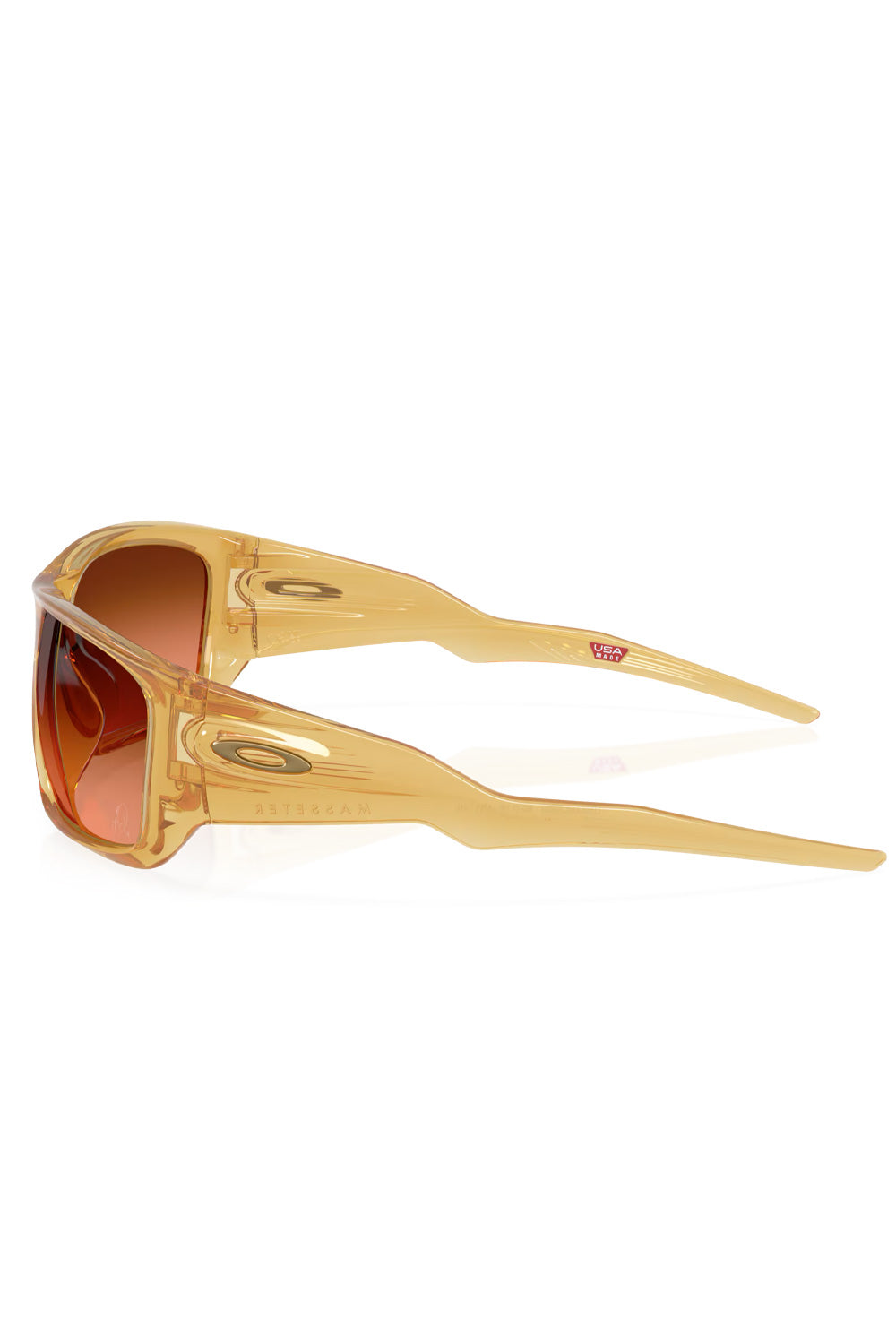 Side profile view of the translucent yellow-curry O-Matter frame highlighting the wide temple construction and satin bronze Oakley ellipse logo.