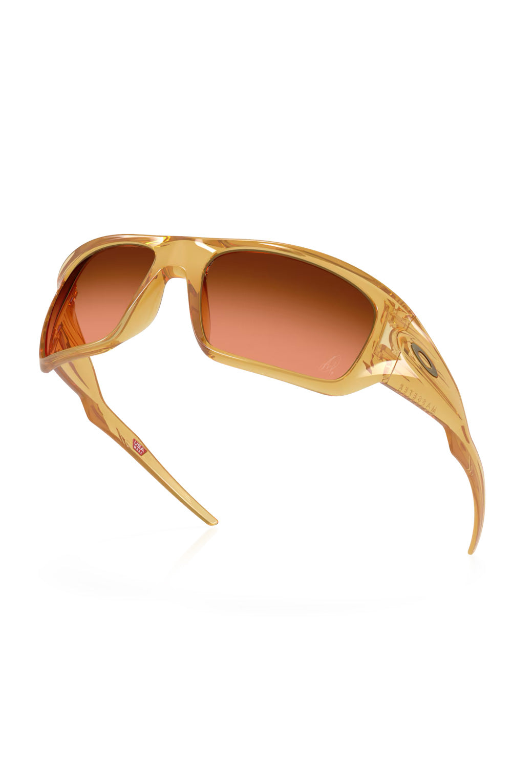 Dynamic angled view of the Oakley Masseter sunglasses, showing the inner temple details and USA Made stamp inside the Trans Light Curry frame.