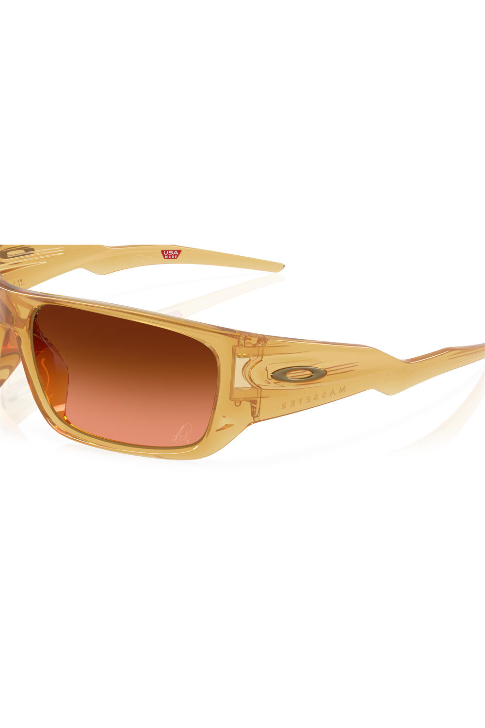 Close-up detail of the Prizm Brown Gradient lens featuring the custom Alexia Putellas signature laser-etching in the bottom corner.