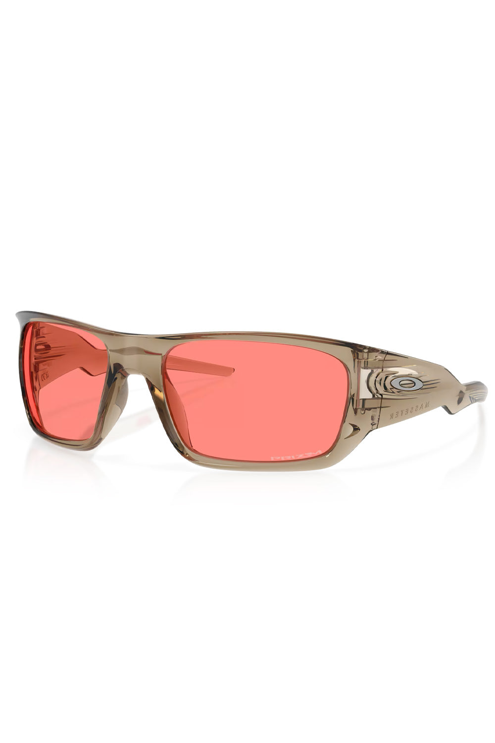 Three-quarter front view of the translucent beige Oakley Masseter sunglasses in Trans Sand featuring vibrant pink-tinted Prizm Peach lenses.