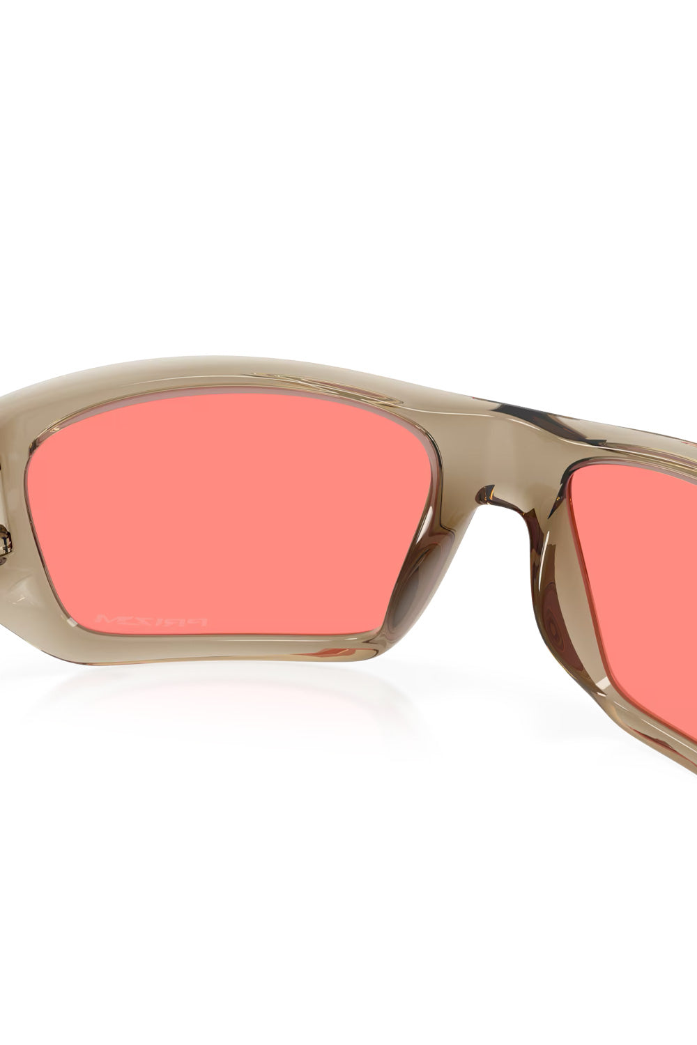 Interior view looking through the bright Prizm Peach lenses of the translucent sand-colored Oakley Masseter sunglasses frame.