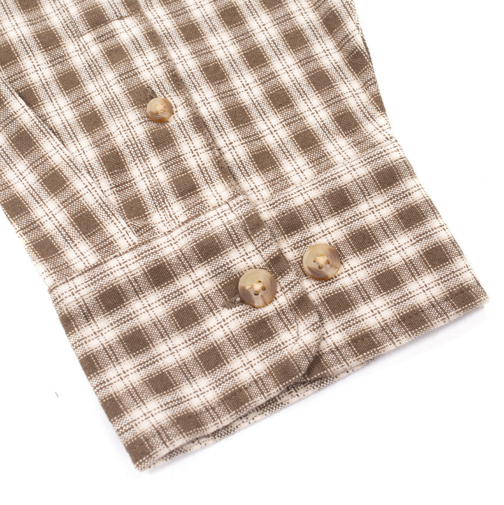 Macro studio perspective of the sleeve cuff on the Obey Bigwig Axel Woven Shirt in Canteen, showing the buttoned gauntlet placket, double faux-horn cuff buttons, and the rich brown and cream woven grid check pattern.
