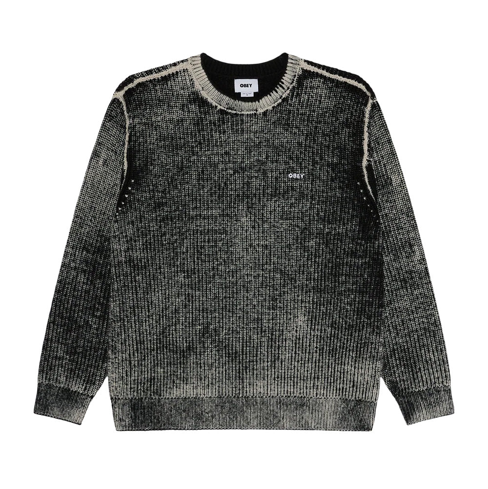 Front flat lay view of the Obey Spray Effect Sweater in Dark Black, showcasing a heavy ribbed crewneck knit silhouette treated with an airbrushed spray-dye fade transition from faded cream at the edges to deep black through the core, featuring exposed contrast raglan shoulder seams, ribbed cuffs and hem, and a small white embroidered OBEY logo on the left chest.