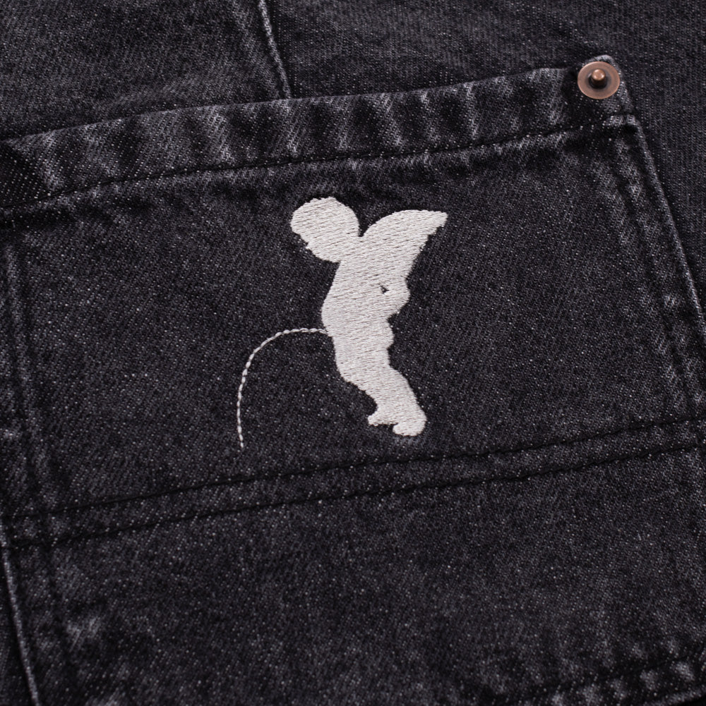 Macro studio perspective of the back pocket on the Token Alphabet Jeans, focusing on the dense white satin-stitched embroidery depicting the winged Manneken Pis angel cherub, copper corner rivet, and faded charcoal acid-wash denim weave.