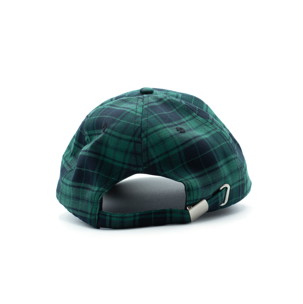 Rear studio perspective of the Token Pissing Angel Cap, displaying the green and navy plaid check pattern across the six-panel crown, matching fabric top button, embroidered ventilation eyelets, an arched back opening, and an adjustable matching plaid strap closure secured by a brushed silver metal slider buckle.