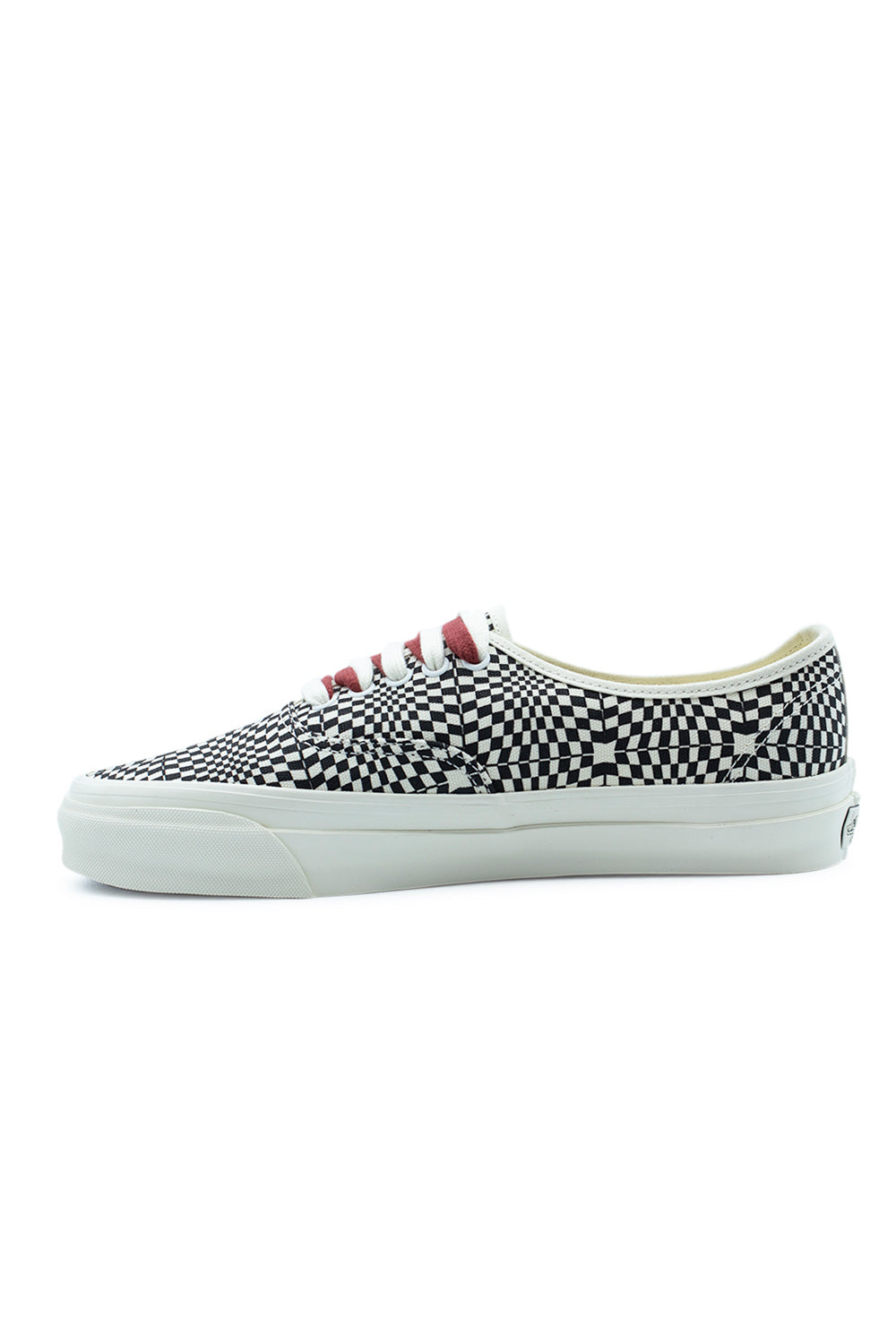 Medial side profile view of the Vans LX Authentic 44 Heritage Black sneaker, illustrating the continuous distorted checkerboard canvas print, clean off-white foxing tape sidewall, and red lace accents.