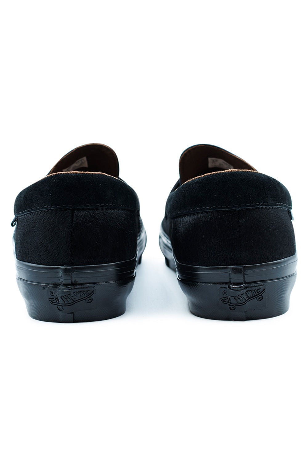 rear angle Vans LX Loafer 53 black pony hair highlighting padded collar, glossy foxing tape and durable vulcanized outsole, premium Vans footwear with timeless all-black finish