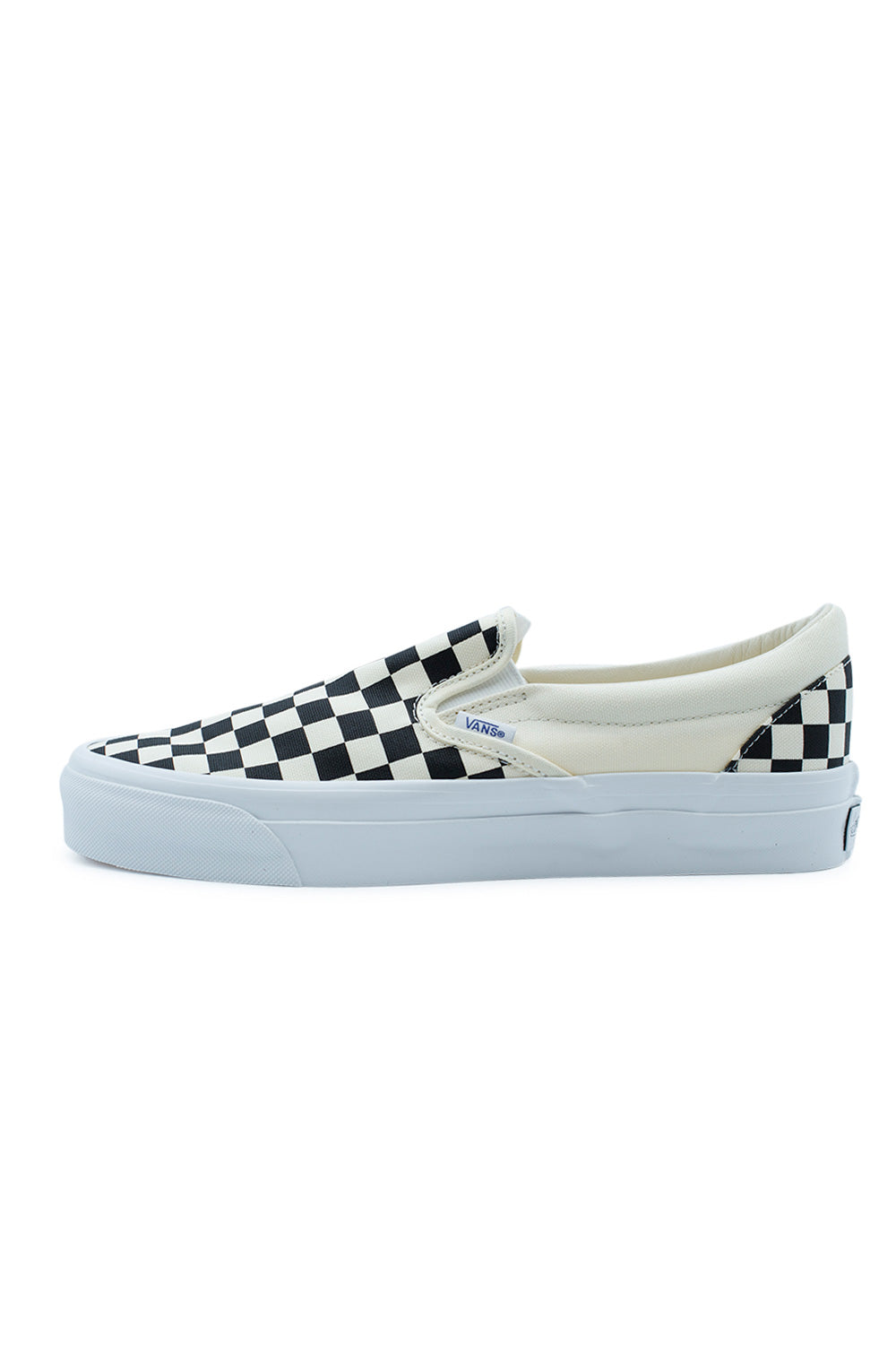 Lateral side view of the Vans LX Slip-On Reissue 98 sneaker in Checkerboard Black and Off White, showcasing the higher glossy white rubber sidewall.