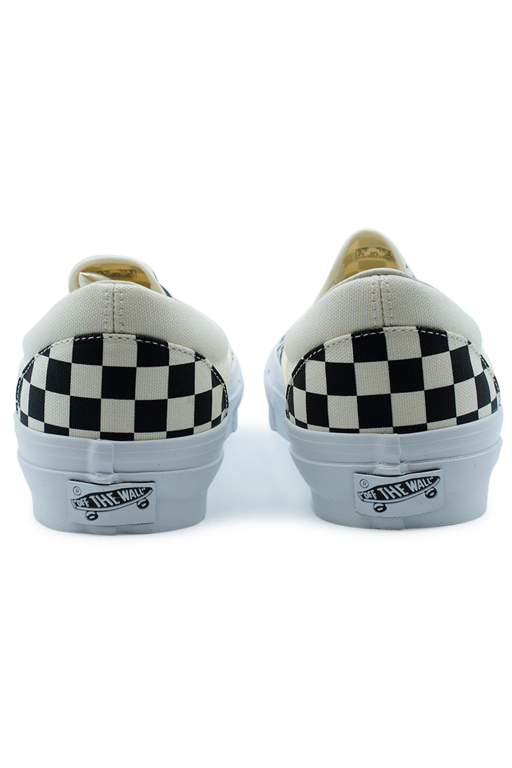 Rear heel view of the Vans LX Slip-On Reissue 98 sneakers showing the checkerboard pattern on the heel counters and the classic white Off The Wall rubber license plates.