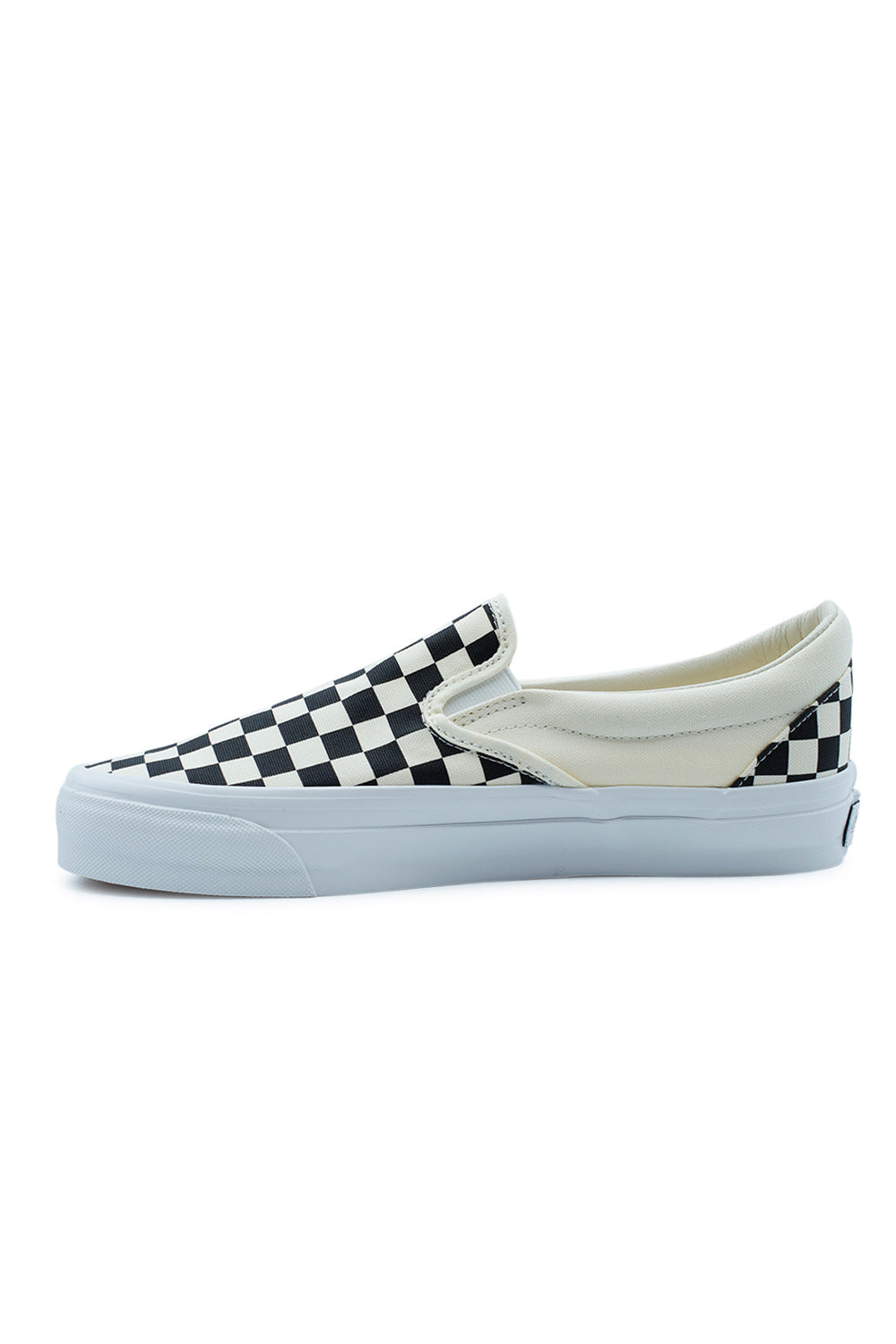 Medial side view of the Vans LX Slip-On Reissue 98 sneaker, detailing the clean white canvas panels and the stitching transition to the checkerboard pattern.