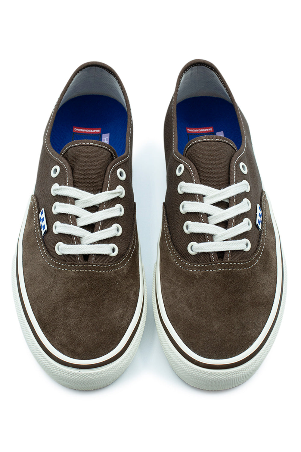 Top-down view of a pair of Vans Skate Authentic low-top sneakers in Vintage Cocoa brown, highlighting the suede toe box, white flat laces, white metal eyelets, and vibrant blue PopCush insoles featuring red Vans Skateboarding branding.
