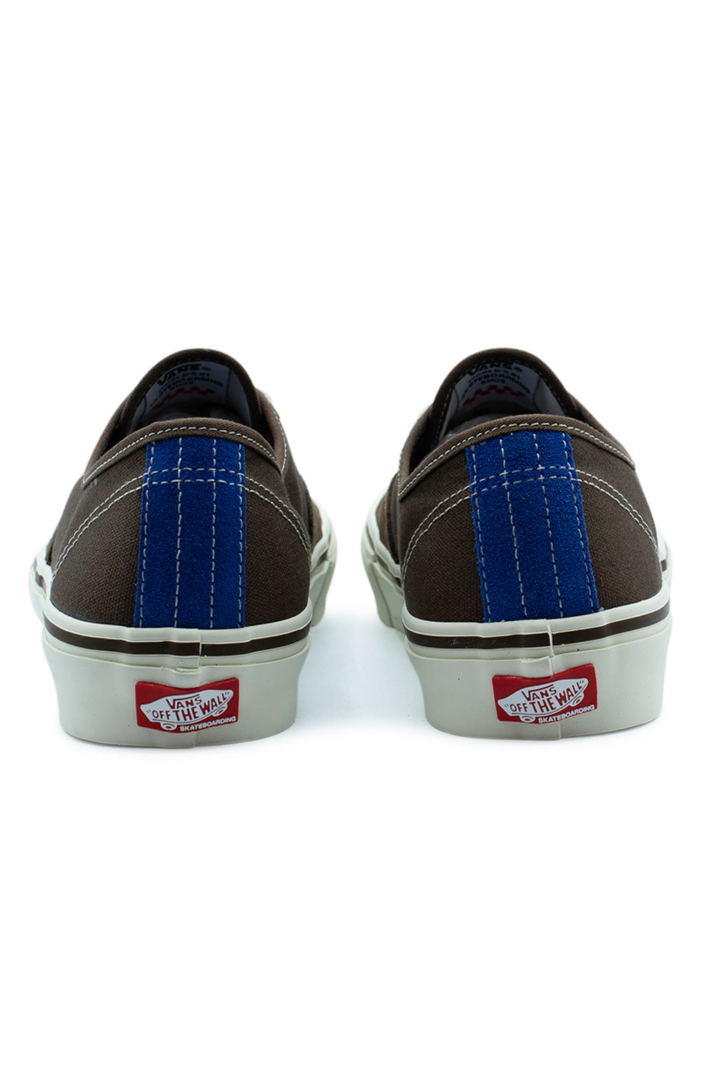 Rear view of the heels of the Vans Skate Authentic Vintage Cocoa shoes, showcasing the vertical bright blue suede accent stripe with double white contrast stitching and the red Vans Off The Wall Skateboarding rubber heel plate.