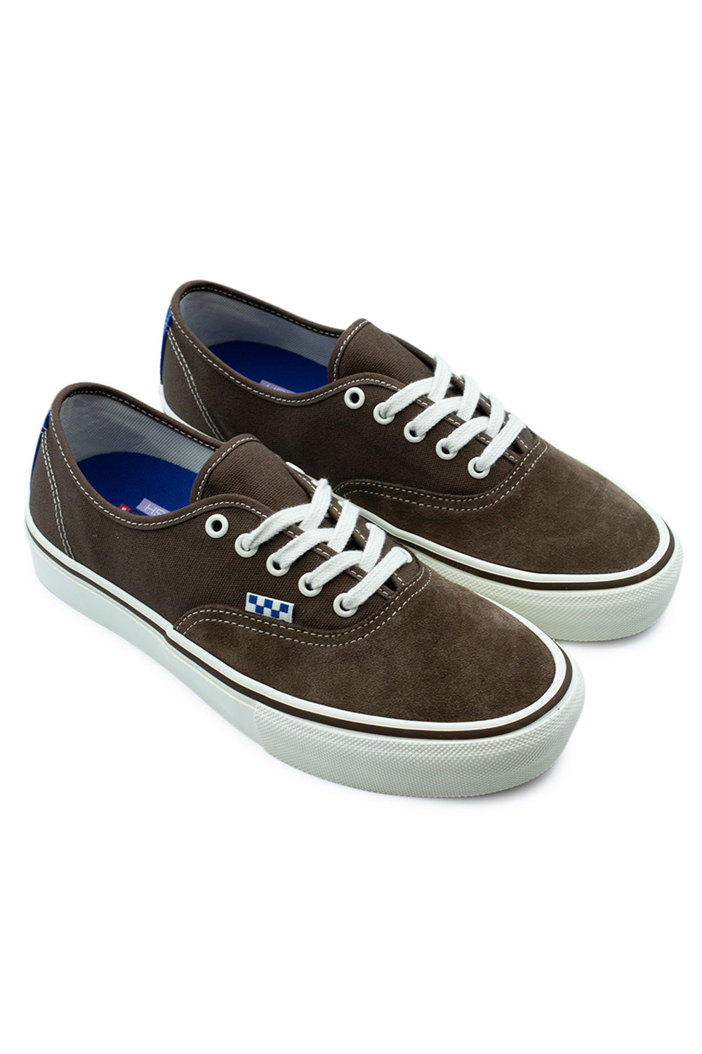 Three-quarter perspective studio shot of the Vans Skate Authentic Vintage Cocoa sneakers, showing the reinforced low-top skateboarding construction, off-white foxing tape, and blue suede heel detail.
