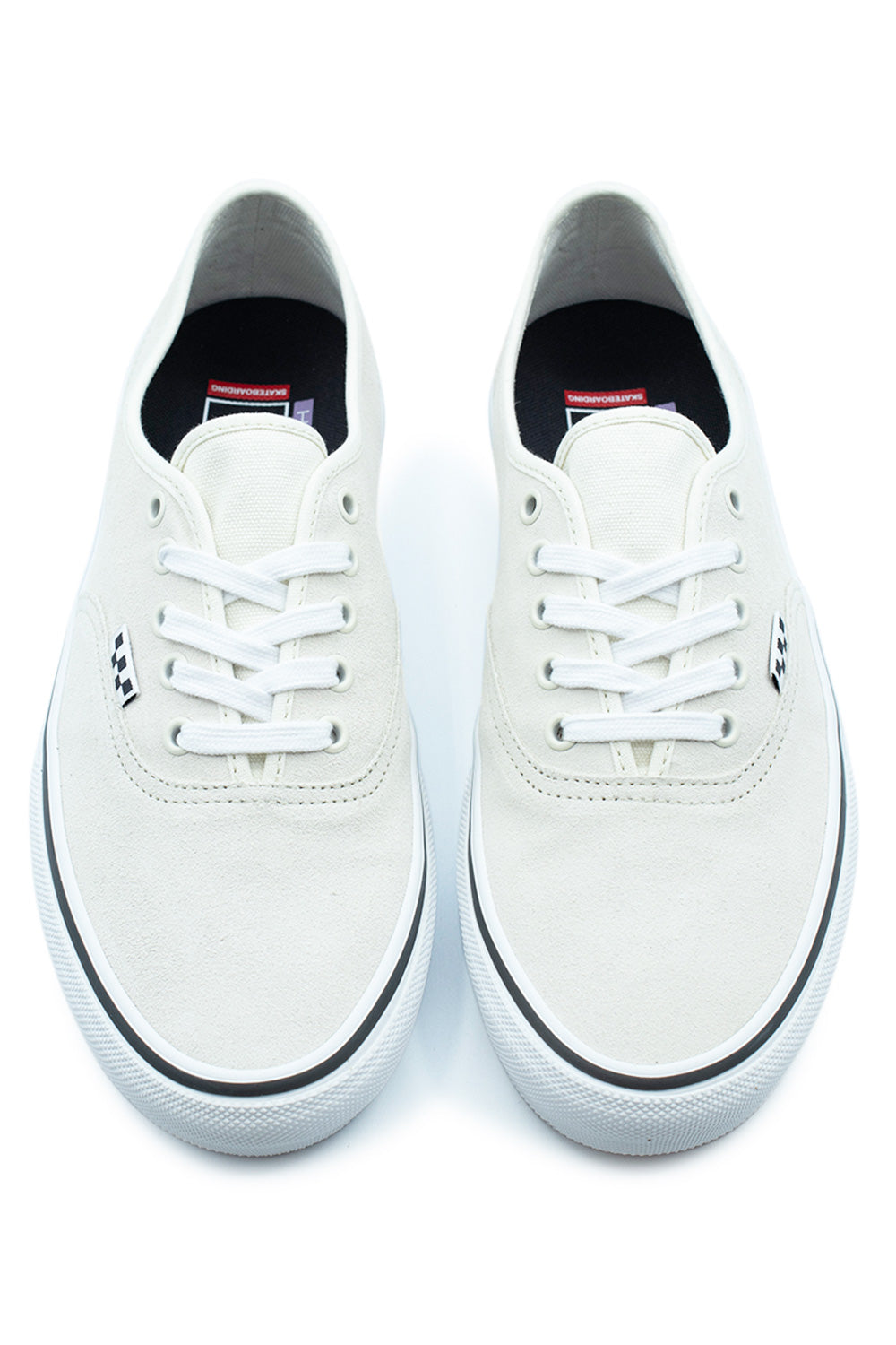 Top-down perspective of a pair of Vans Skate Authentic low-top sneakers in White / Gunmetal, showing the off-white suede toe box, white flat cotton laces, silver-toned metal eyelets, and dark insoles with red Vans Skateboarding branding.