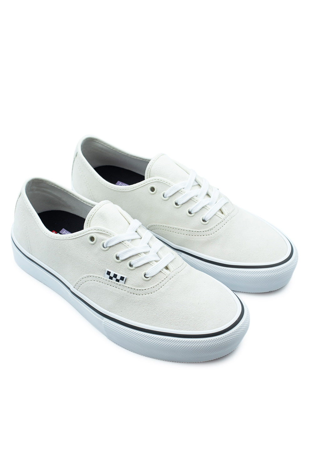 Three-quarter perspective studio shot of the off-white Vans Skate Authentic sneakers, showcasing the reinforced full-suede skateboarding construction, low-profile collar, and textured white rubber toe bumper.