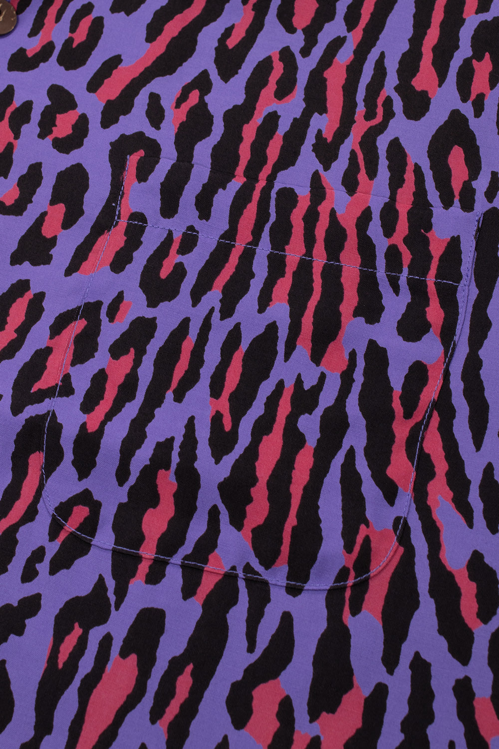 Detailed shot of the left chest pocket on the purple Wacko Maria shirt, showing how the animal print pattern seamlessly aligns with the body fabric.