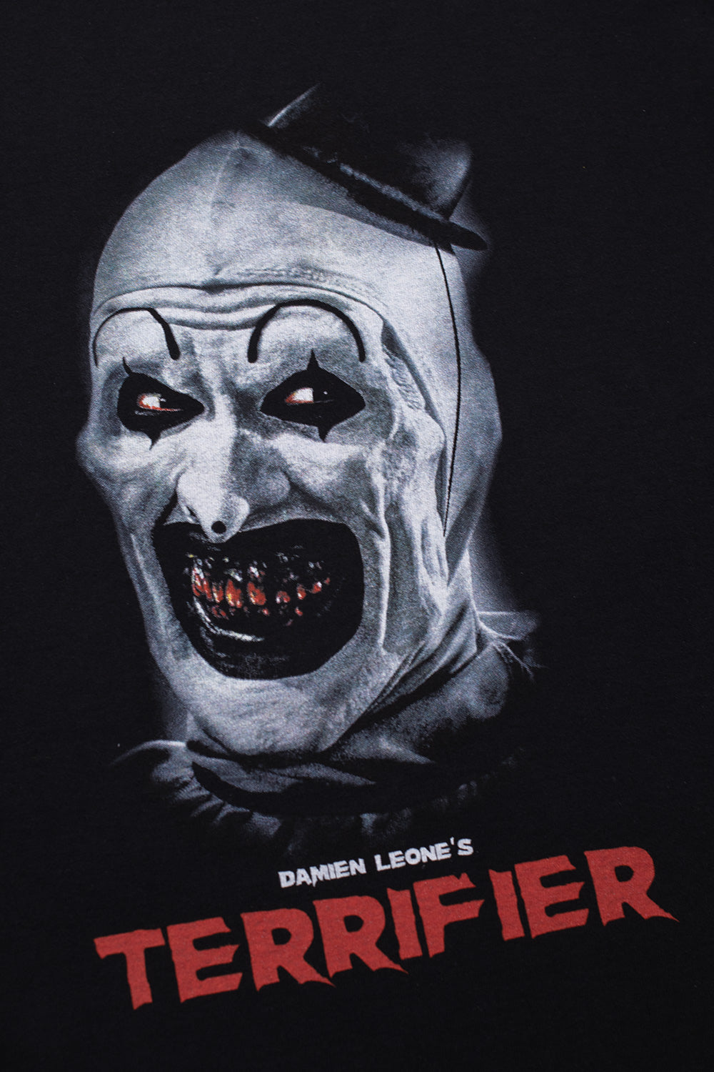 Close-up of Art the Clown print on Wacko Maria x Terrifier T-shirt, bold horror movie graphic with Damien Leone’s Terrifier logo on heavyweight black cotton fabric