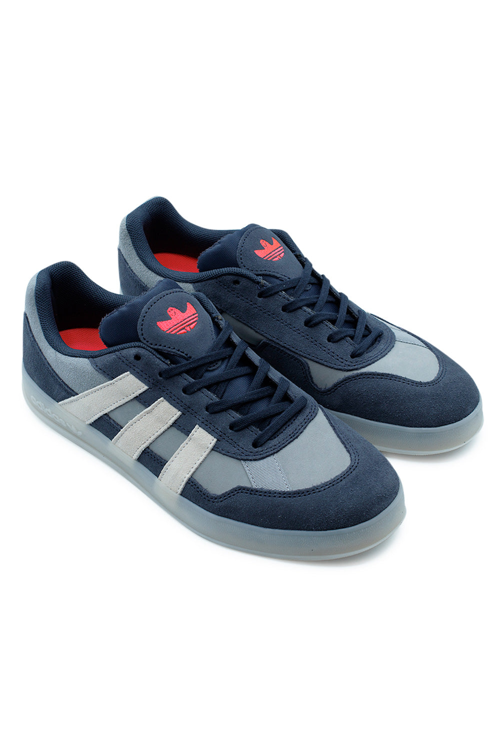 Studio shot of a pair of adidas Aloha Super Mark Gonzales sneakers placed together at an angle, showing the contrast between navy nubuck and light grey panels.
