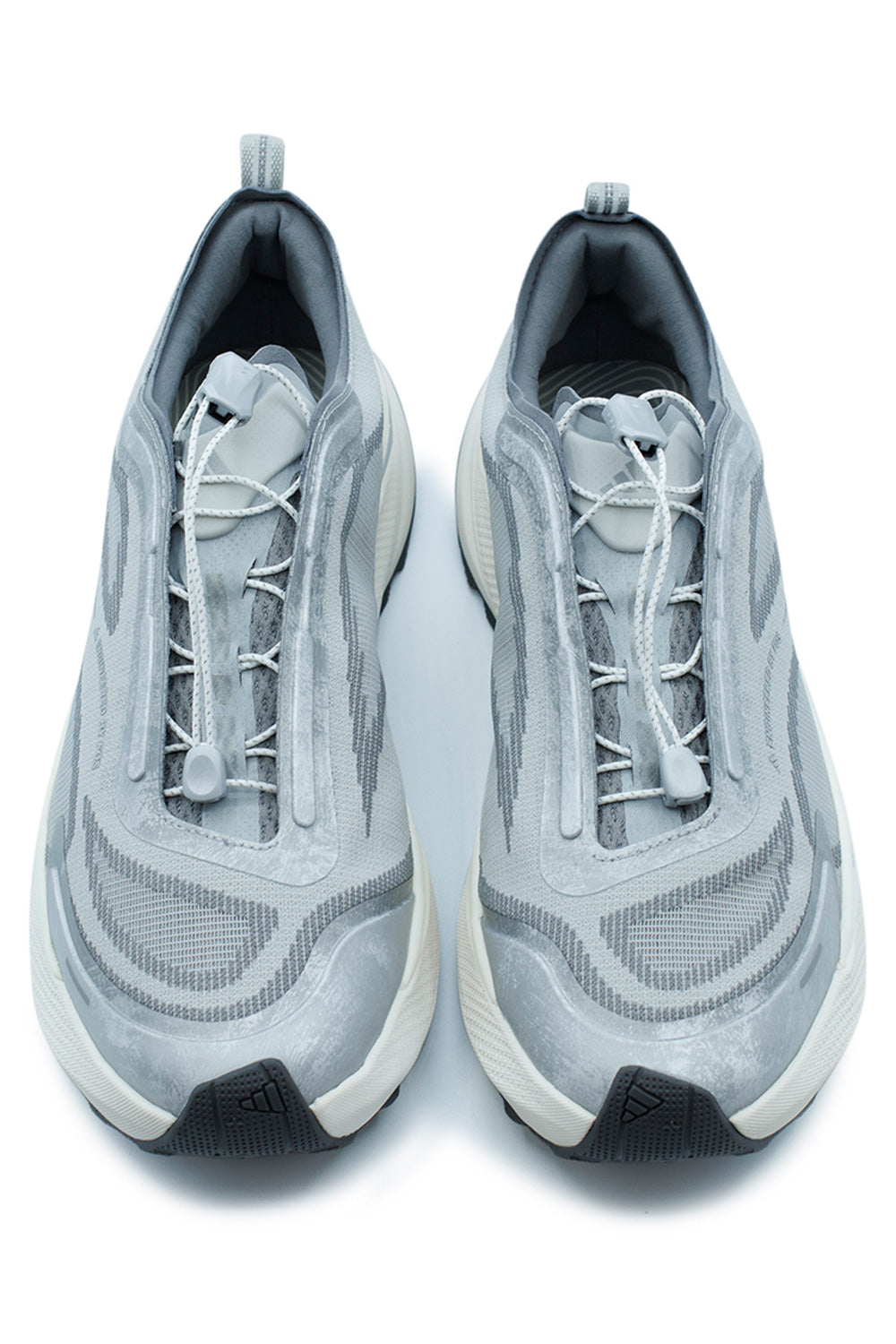 Top-down view of a pair of adidas Holo Peak Core Black sneakers, highlighting the progressive white quick-lacing speed toggle system and layered dark grey fabrics.