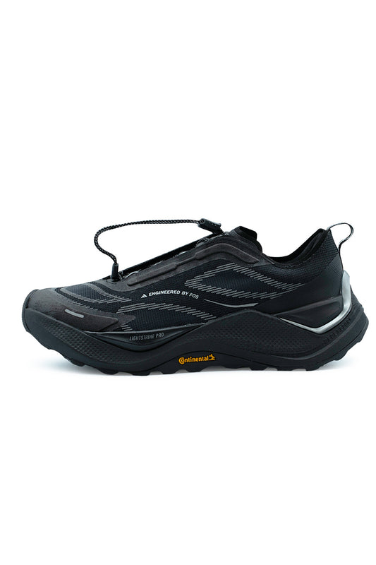 Lateral side profile view of the Adidas Holo Peak trail sneaker in Core Black and Iron Metallic, showcasing the breathable textile upper with Engineered by FOS linear graphics, chunky black Lightstrike Pro foam midsole, metallic silver heel clip counter, and rugged Continental rubber outsole with orange logo branding.