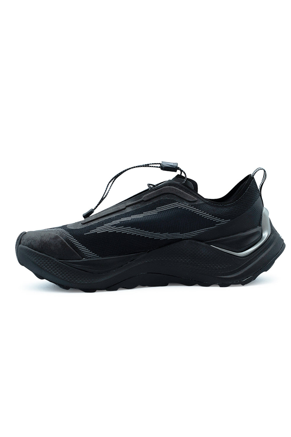 Medial side profile view of the Adidas Holo Peak shoe in black, displaying the dynamic linear knit weave upper, seamless synthetic protective overlays, and curved geometric trail midsole profile.
