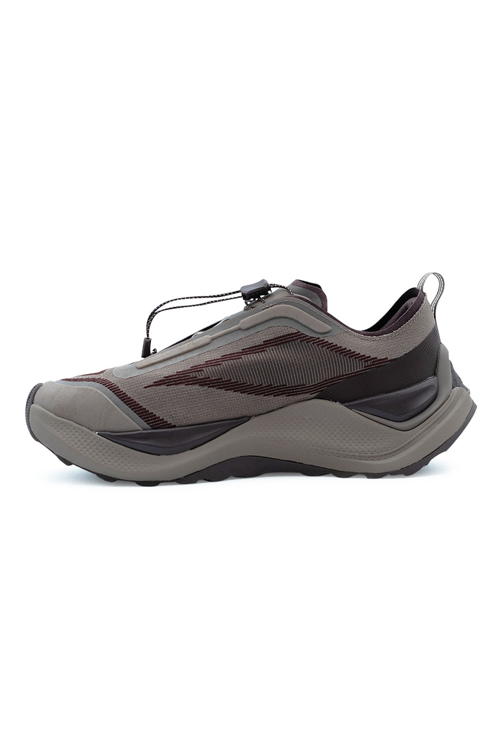 Medial side profile view of the Adidas Holo Peak shoe in earth tones, featuring the seamless synthetic overlays, ventilated knit textile base, dynamic maroon accent stripes, and curved dual-density trail midsole.