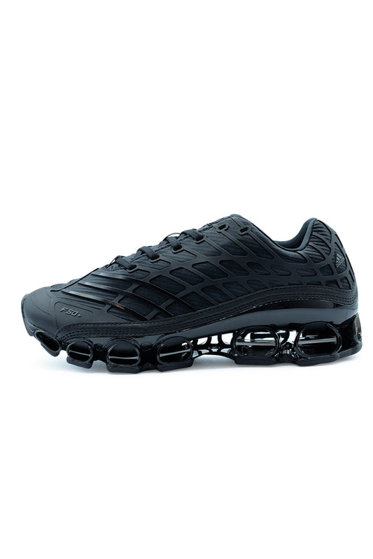 Adidas Megaride F50 Core Black sneaker side view showcasing futuristic F50 structure, black mesh and synthetic upper, Megaride cushioning system, and performance-inspired lifestyle design