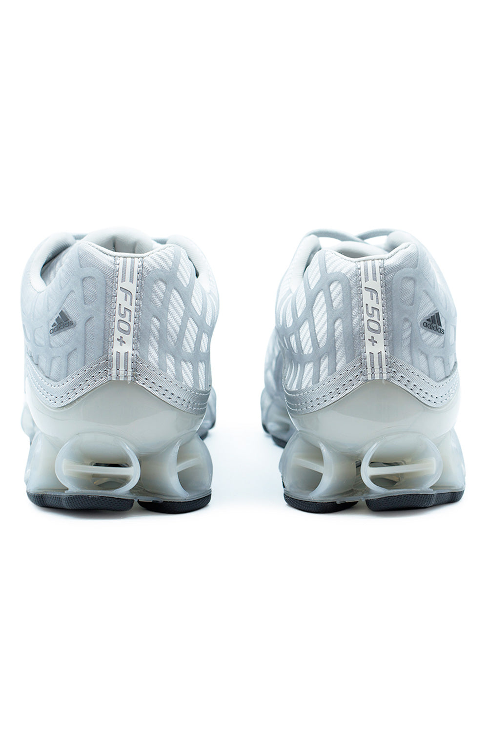 Rear angle of Adidas Megaride F50 Silver Metallic trainers highlighting heel support structure, sculpted cushioning midsole, adidas logo branding and aerodynamic sport design.