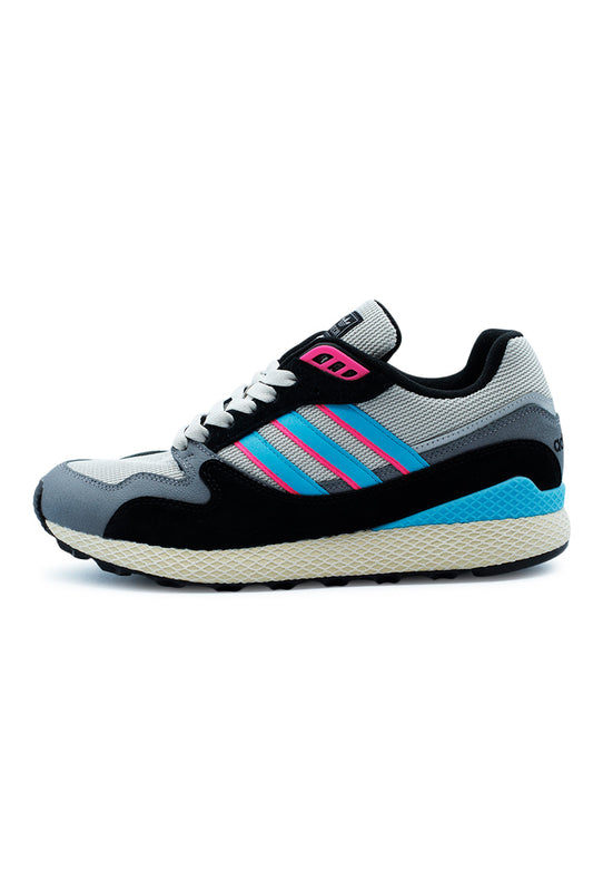 Lateral side view of the Adidas Oregon Ultra Tech sneaker featuring a grey mesh upper, black suede overlays, bright blue three stripes with pink accents, and a distinctive web-structured Dellinger midsole.