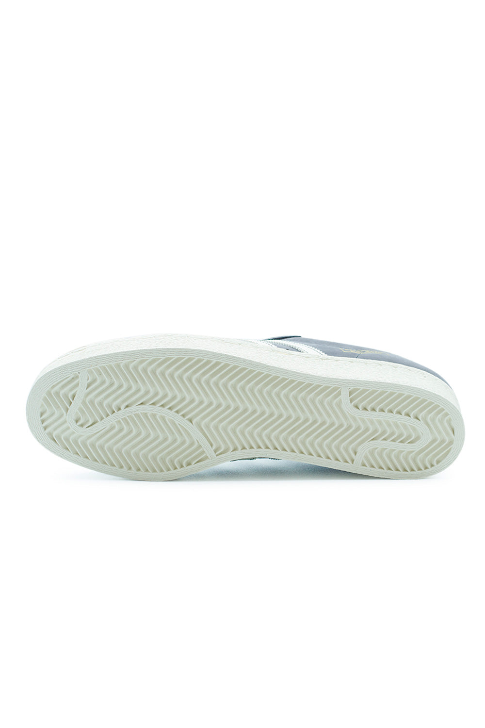 Outsole view of Adidas Superstar 80 ADV skateboard shoes with herringbone traction pattern for grip and control