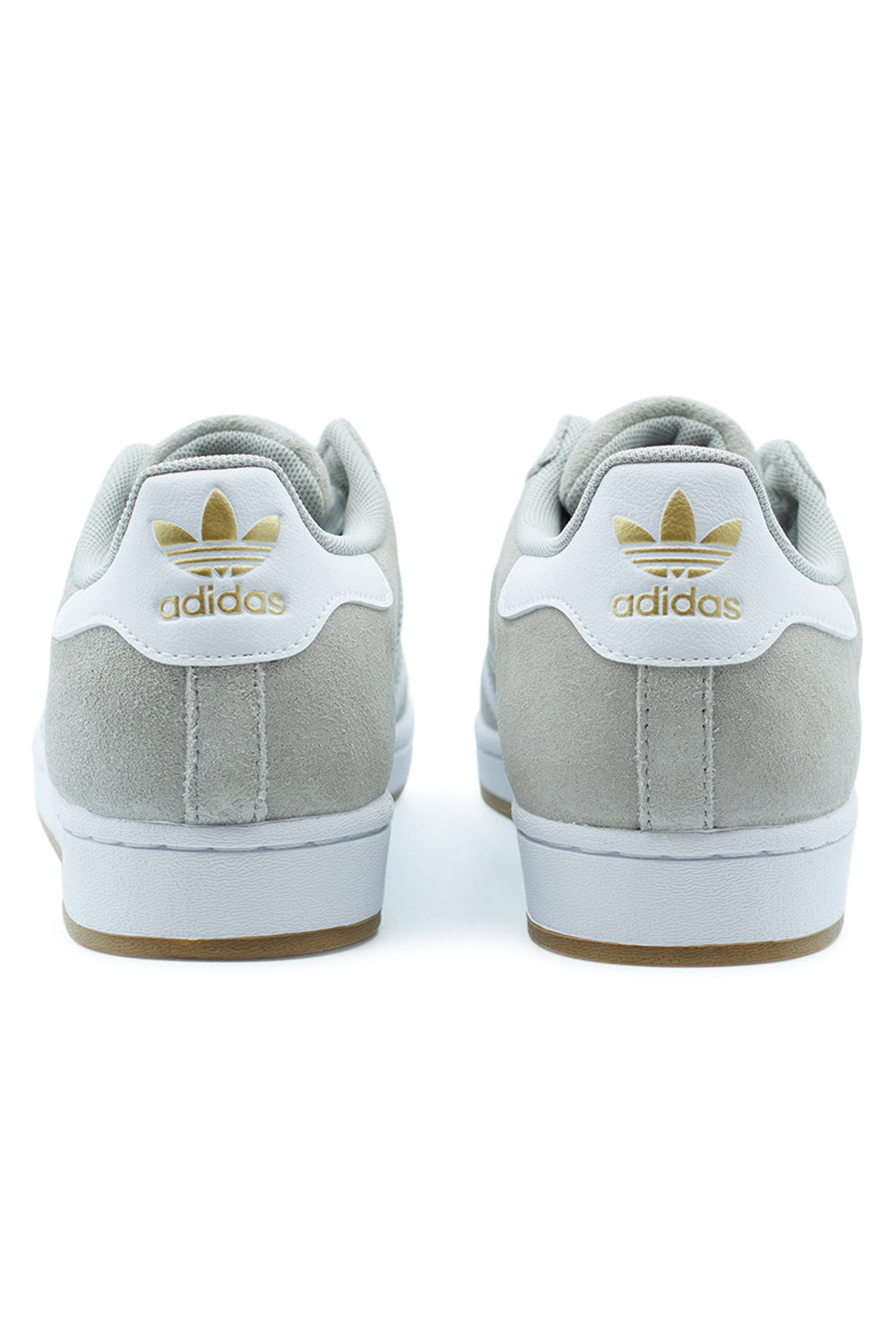 Rear detail of adidas Superstar ADV Cloud White heel tab with Gold Metallic Trefoil logo, suede upper and reinforced construction – iconic skate sneaker inspired by classic basketball heritage.