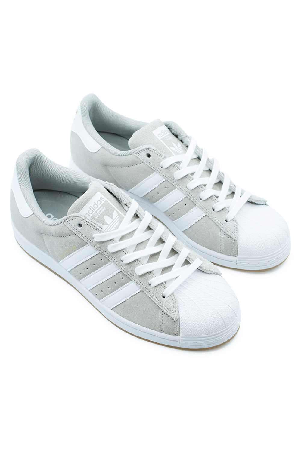 Pair of Adidas Superstar ADV Clear Granite / Cloud White featuring double-stitched lace panel, hidden ADITUFF reinforcement and durable gum rubber outsole – premium skateboarding shoe for street and park.