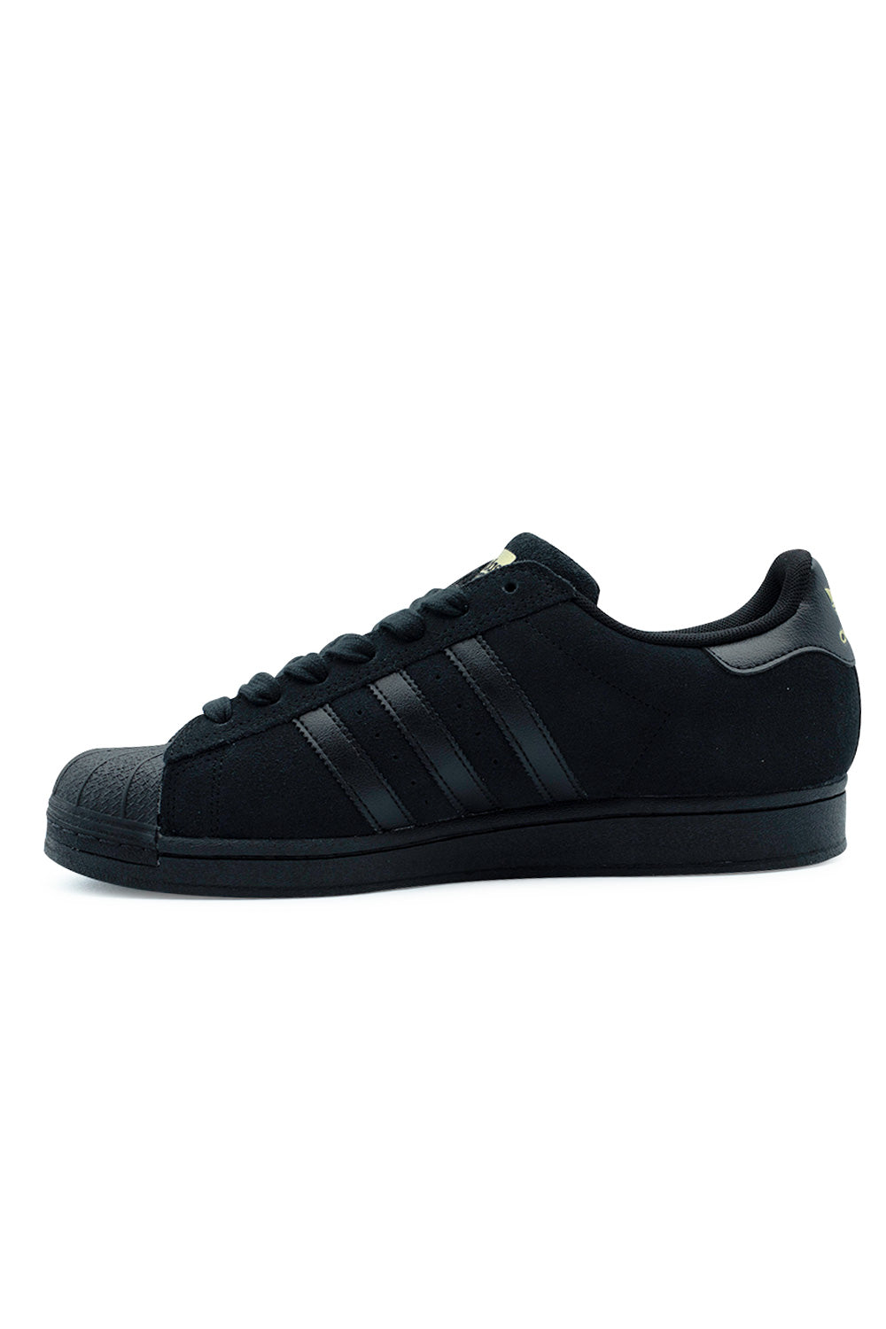 Medial side profile view of the Adidas Skateboarding Superstar ADV in Core Black, illustrating the clean inner suede quarter panel, tonal black serrated leather 3-Stripes, and textured rubber midsole sidewall.