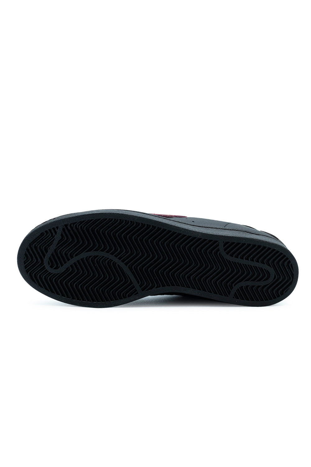 Full bottom perspective of the all-black rubber outsole on the Adidas Superstar ADV, featuring the heritage herringbone traction tread pattern engineered for flexible board control and skate grip.