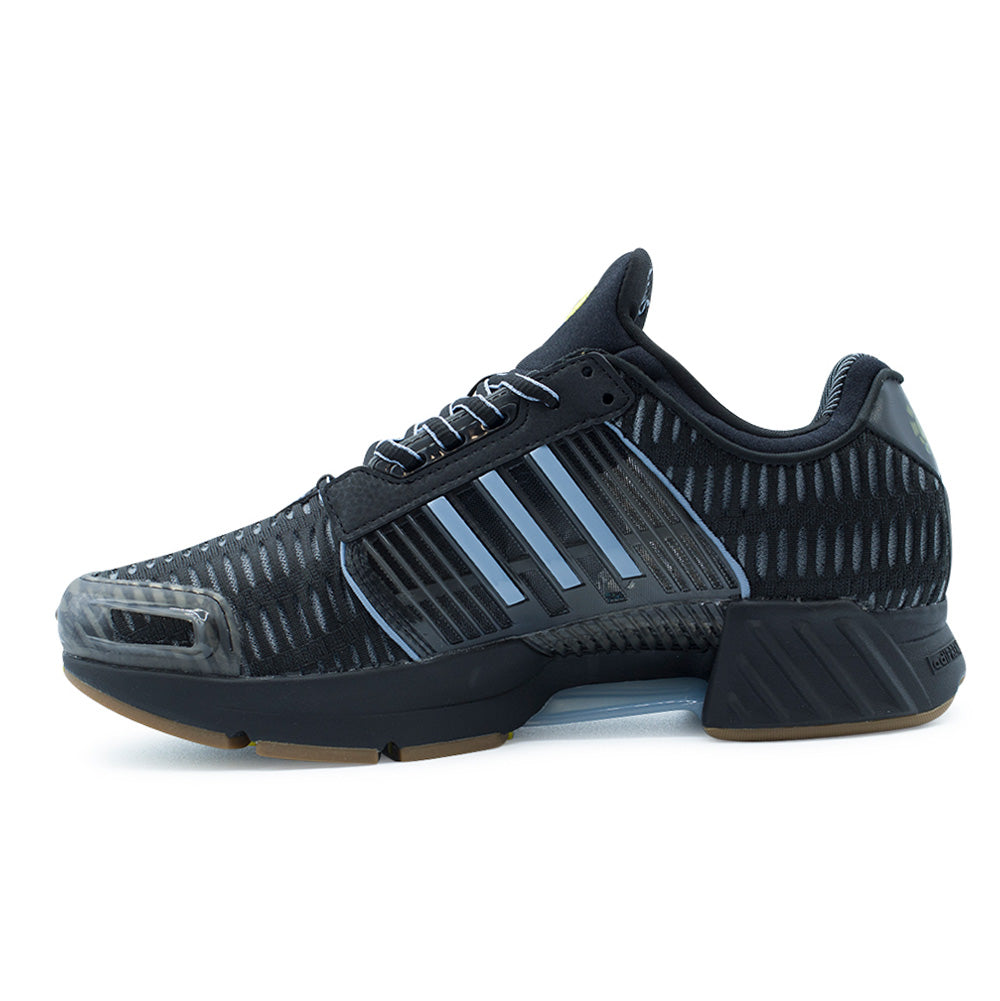 Medial side profile studio view of the adidas x ADWYSD Climacool 1, capturing the molded midfoot TPU stability cage in black and soft blue, textured open-mesh underlay, clear arch ventilation shank, and sculpted black foam heel with grooved shock-absorption ridges.