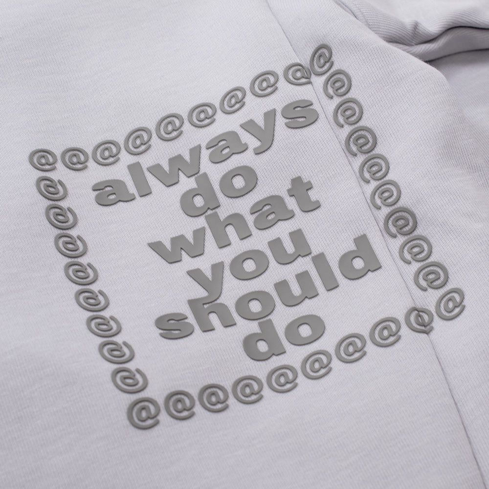 Detailed macro view of the lower back graphic on the adidas x Always Do What You Should Do Hoodie, showcasing the textured 3D puff print of the brand's manifesto quote "always do what you should do" framed by repeated "@" symbols in slate grey.