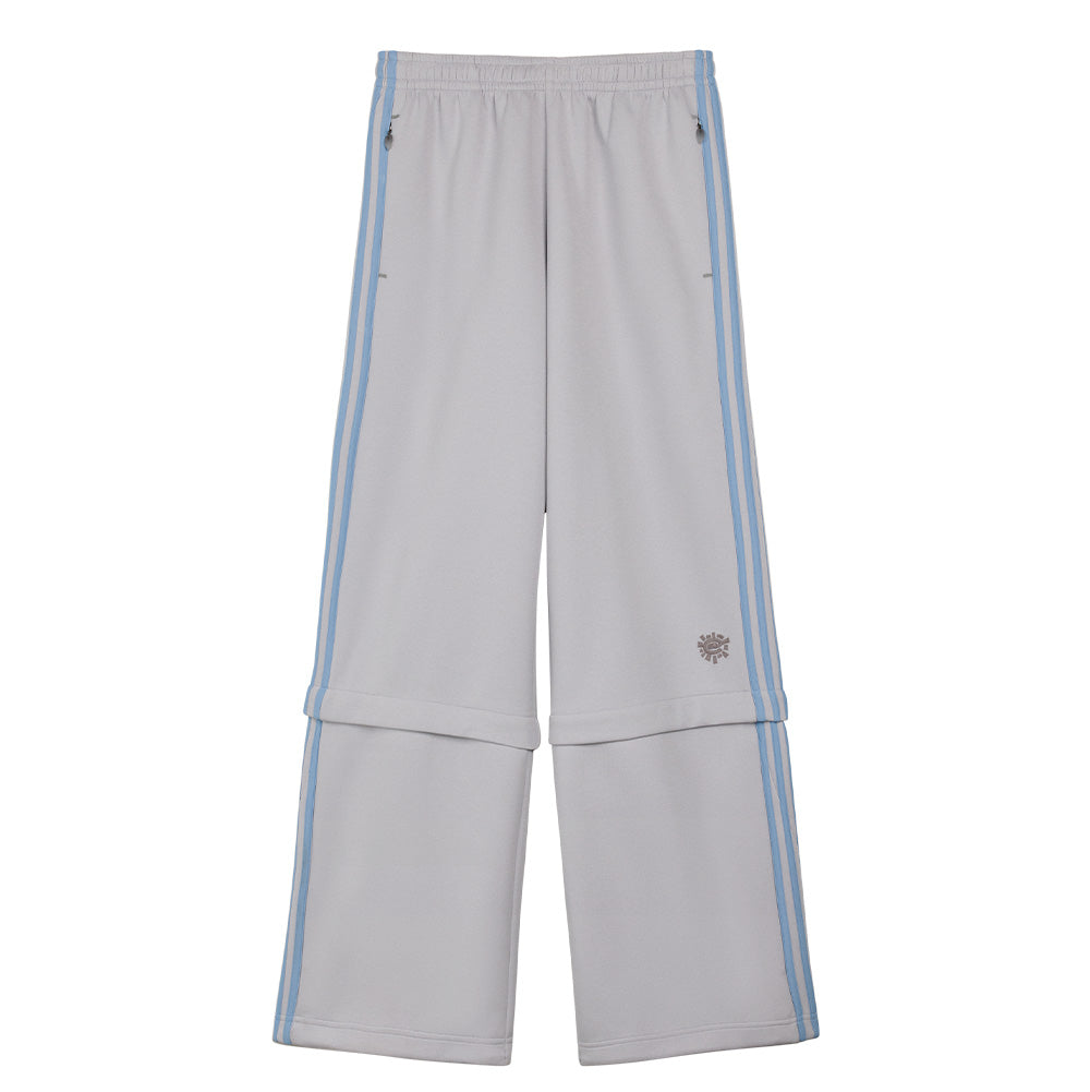 Front flat lay studio perspective of the light grey adidas x ADWYSD Pant, highlighting the elastic waistband with internal drawstrings, curved neon yellow-green front piping, light blue applied Three Stripes on the outer legs, black embroidered Trefoil logo beneath the pocket, and an oval liquid sand bubble patch stitched above the convertible knee flap.