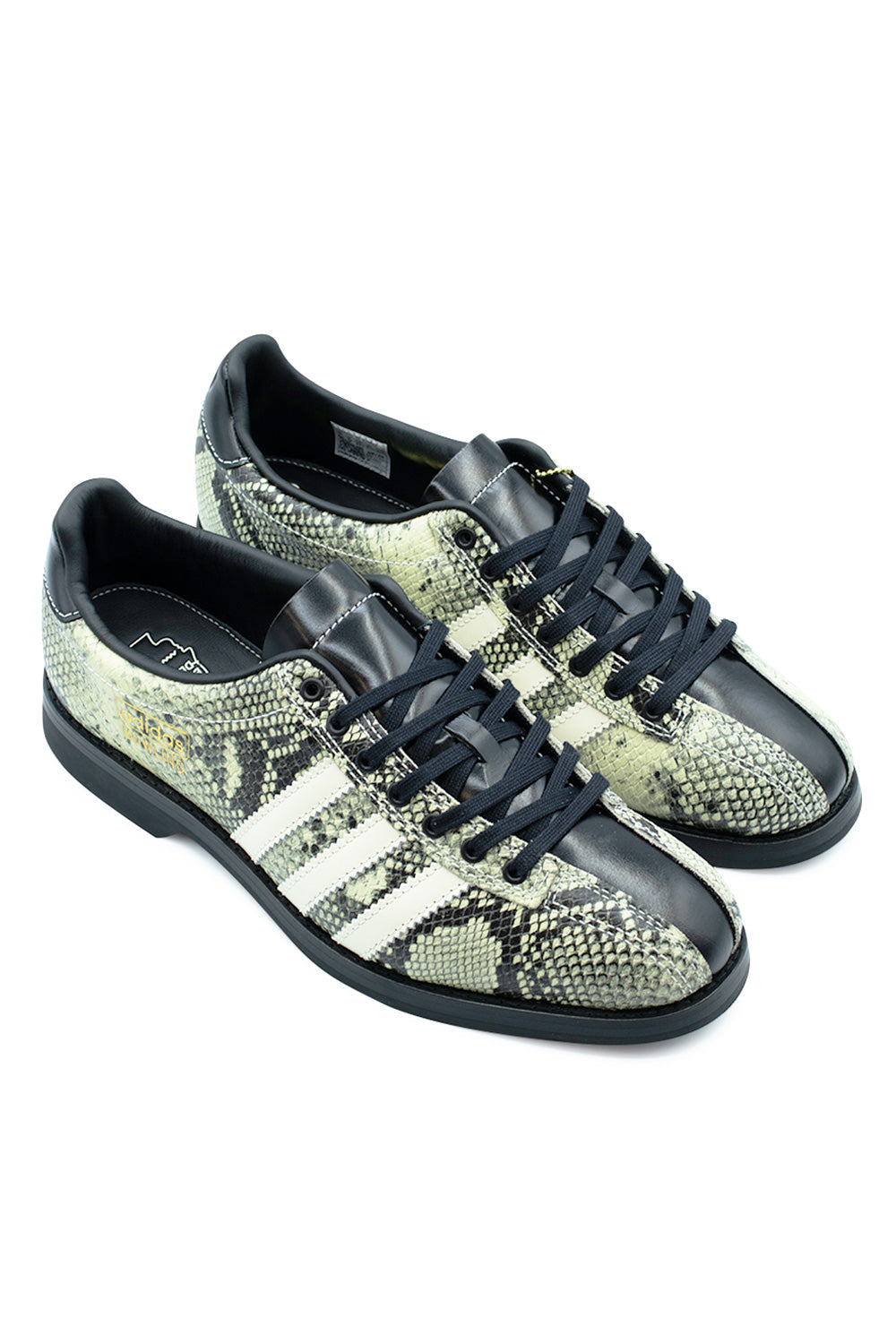 Elevated three-quarter studio view of the Adidas X Brain Dead Bowling shoe, emphasizing the sleek low-profile vintage bowling silhouette, full leather inner lining with collaborative footbed branding, and striking contrast between black patent leather panels and scaled snakeskin print.