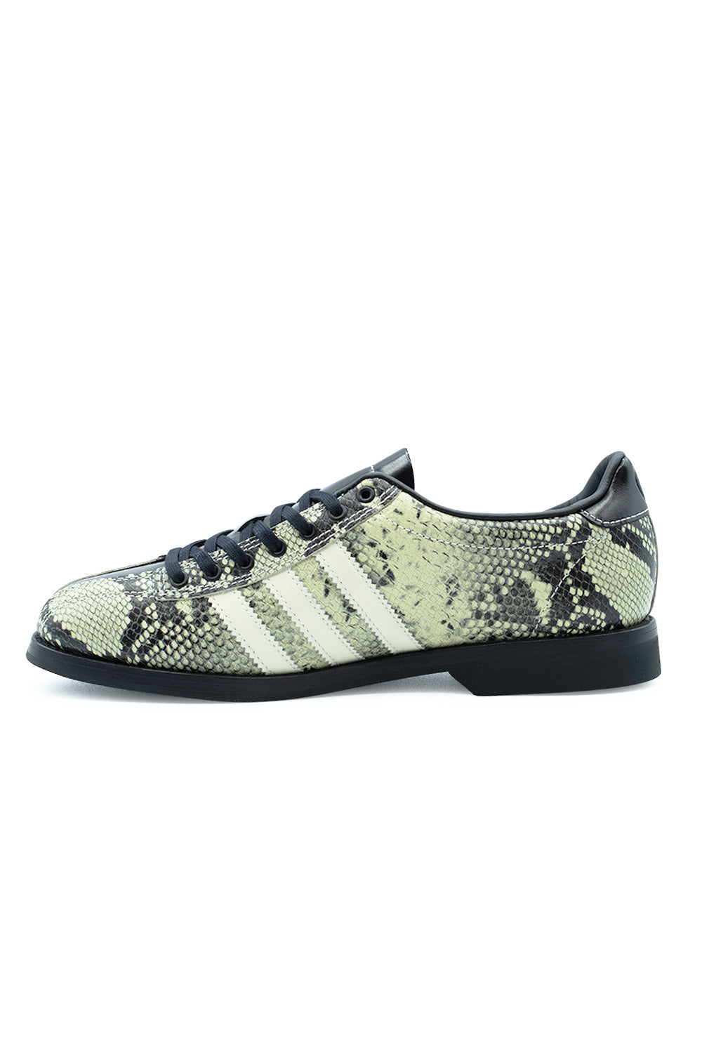 Medial profile shot of the Adidas X Brain Dead Bowling shoe, displaying the continuous snakeskin pattern across the arch, three off-white serrated leather stripes, reinforced black eyelet row, and flat low-profile black rubber sole construction.