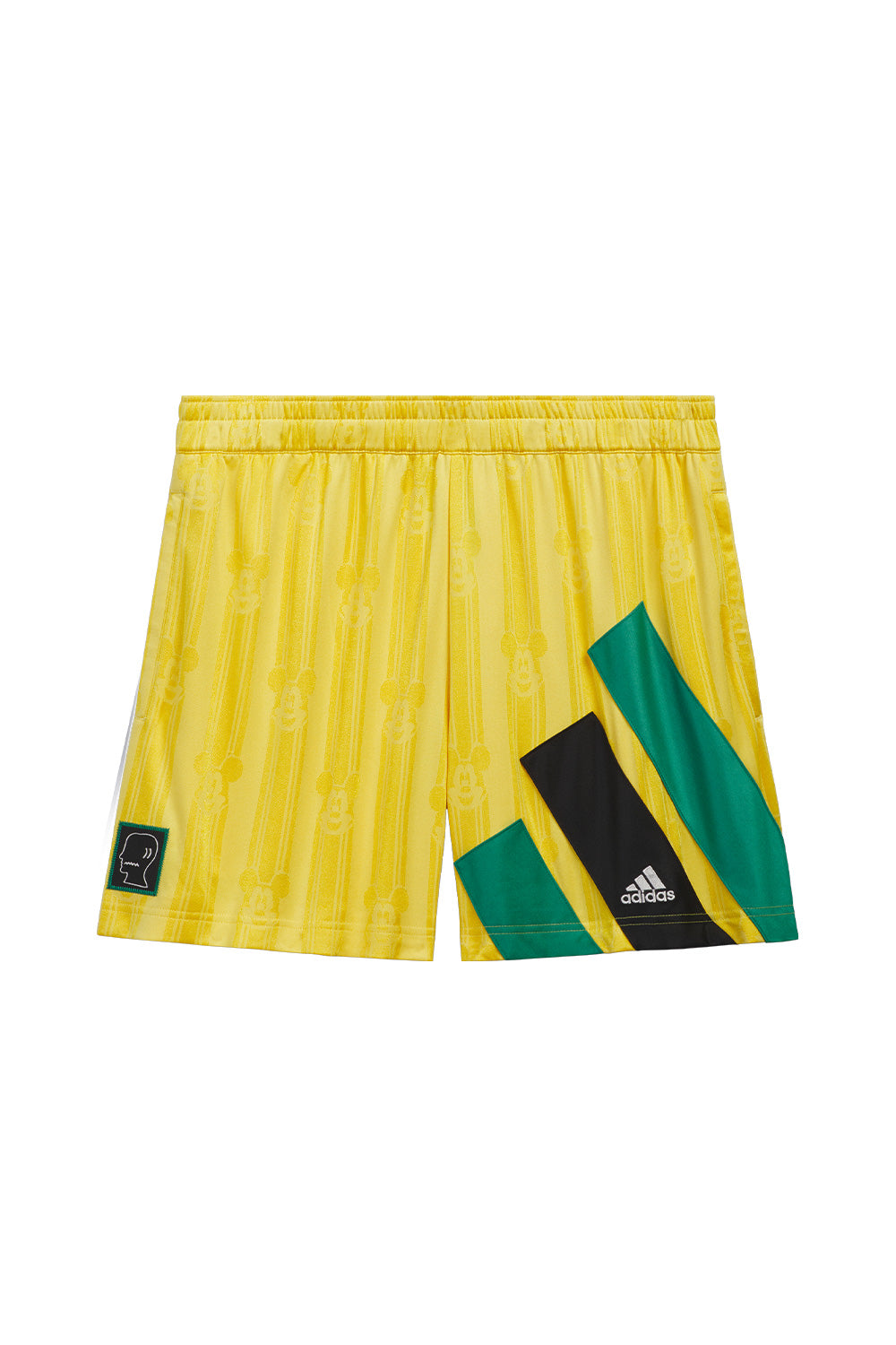 adidas x Brain Dead x Disney Football Short Bold Gold front view featuring all over woven Mickey Mouse pattern, three sewn-on green and black adidas stripes, embroidered adidas logo, Brain Dead logo patch, zip pockets and limited World Cup capsule collection design