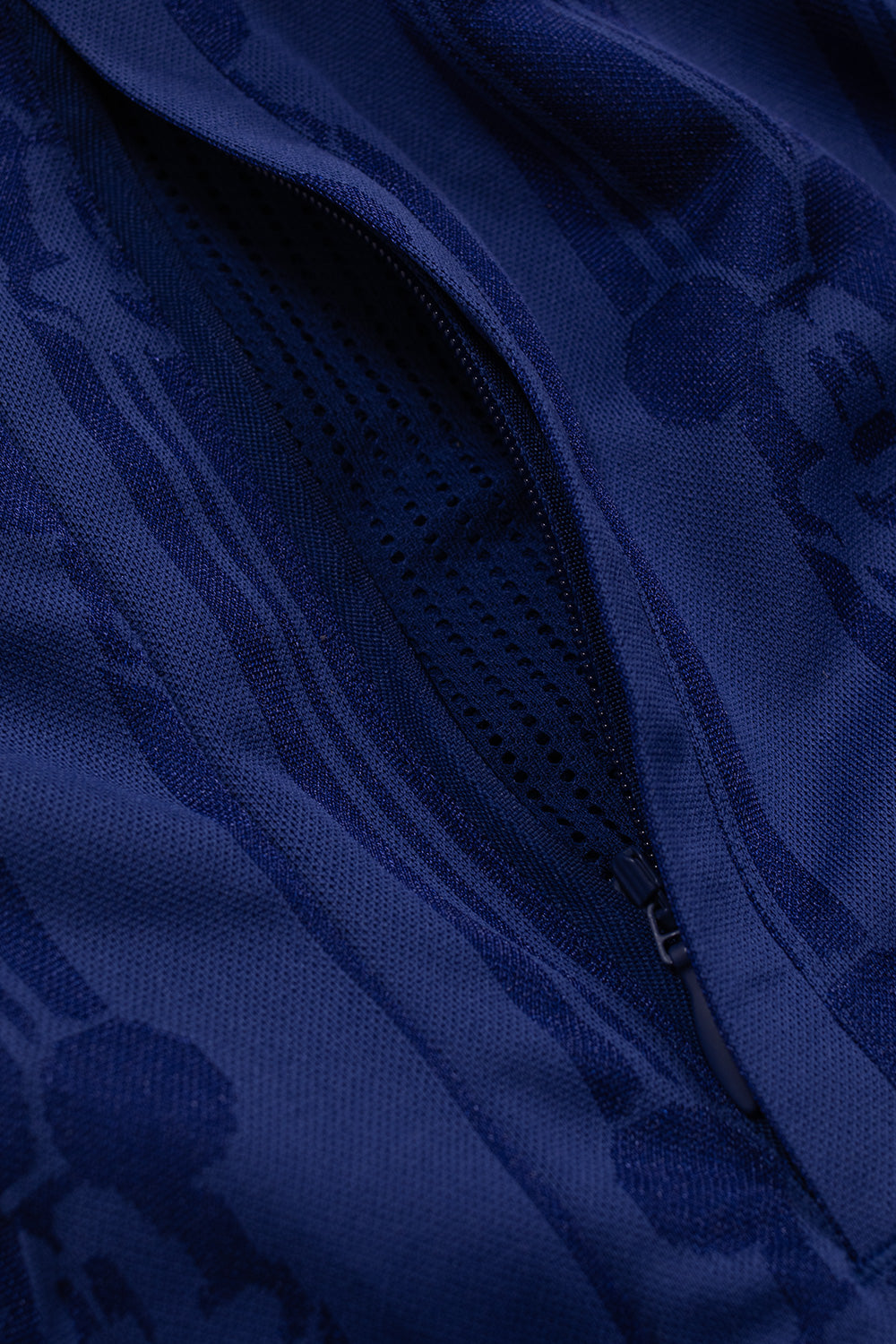 Close-up of the zippered side pocket on the adidas x Brain Dead x Disney Football Short Victory Blue featuring breathable mesh pocket lining, premium construction and functional football design