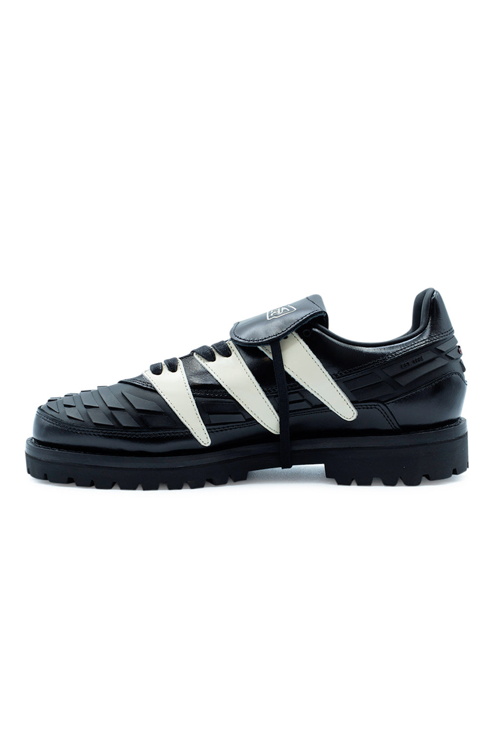 Medial side of the Adidas x Brain Dead x Disney Predator Core Black sneaker displaying premium leather craftsmanship, iconic football-inspired rubber fins, chunky boot sole, luxury lining and collectible Brain Dead x Disney collaboration details.