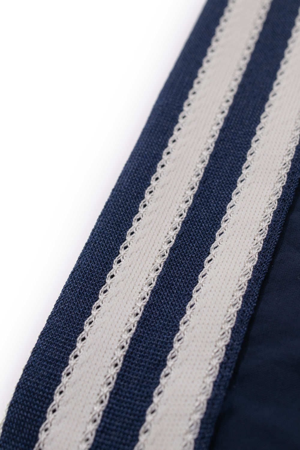Detailed view of the iconic adidas three stripes on the adidas x Brain Dead x Disney Short Core Navy showcasing premium woven side tape and retro football inspired design from the limited capsule collection