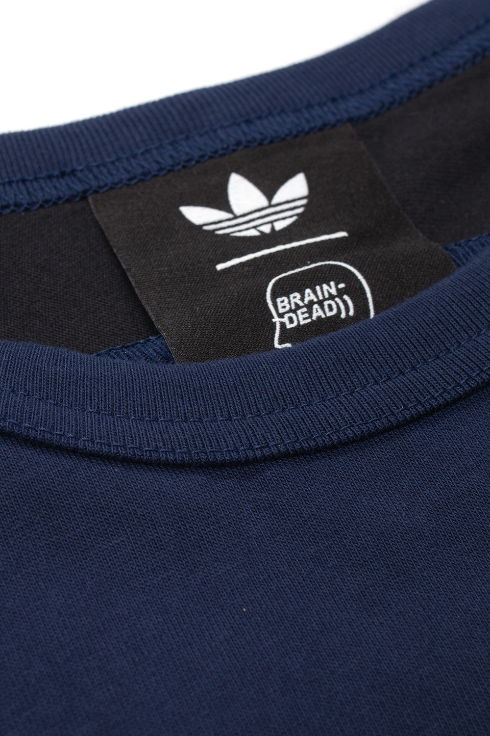 Close-up of the Adidas x Brain Dead x Disney T-Shirt Core Navy collar displaying the collaborative adidas Originals and Brain Dead neck label, heavyweight cotton jersey, premium crewneck construction and authentic limited edition finishing.