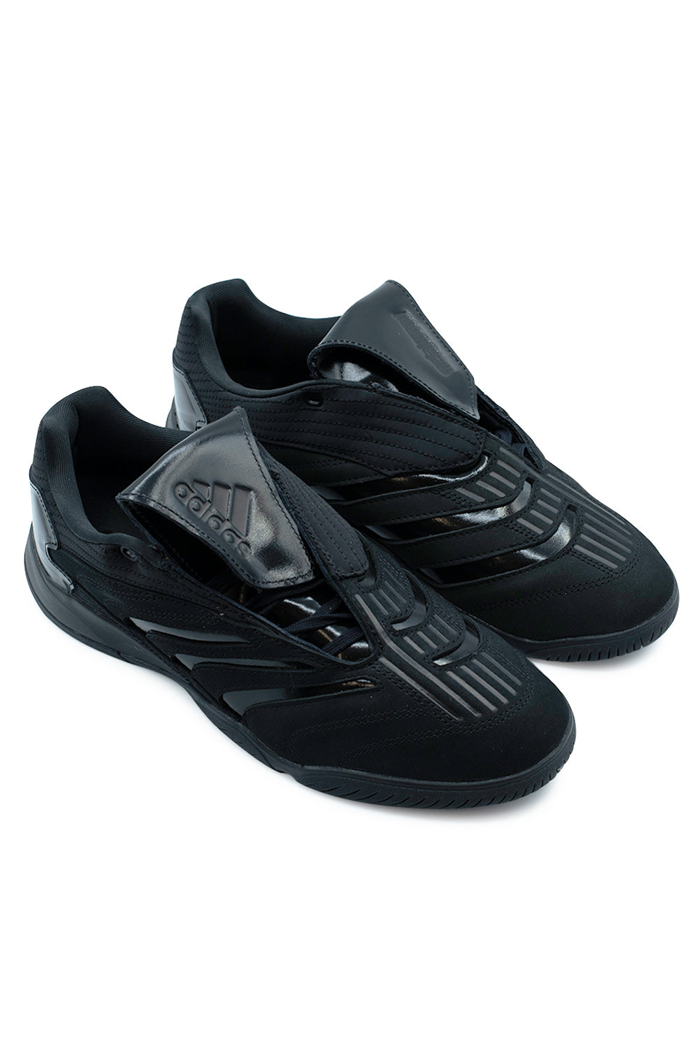 Three-quarter perspective studio shot of the Adidas Skateboarding X Metalwood Studio Predator Sala hybrid shoes, displaying the 2000s football boot aesthetic transformed for skateboarding with an all-black multi-material construction.